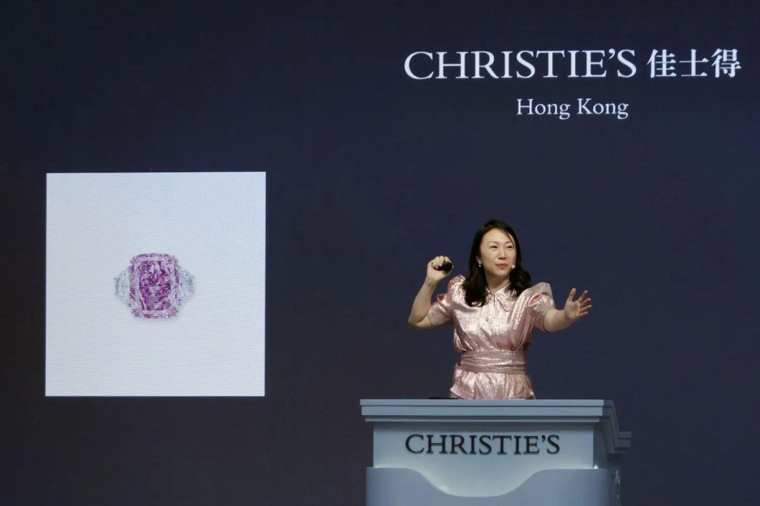 An auctioneer holds the gavel during Christie's auction of Sakura Diamond, a 15.81 carat purple pink diamond ring, in Hong Kong, China May 23, 2021. REUTERS/Joyce Zhou



