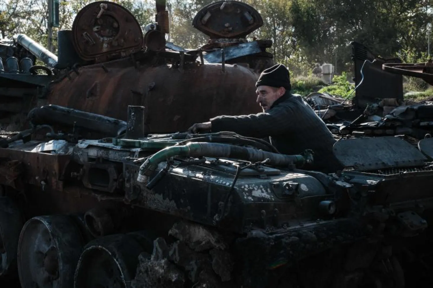 جندي أوكراني أمام دبابة روسية مُدمرة في خاركيف (أ.ف.ب)