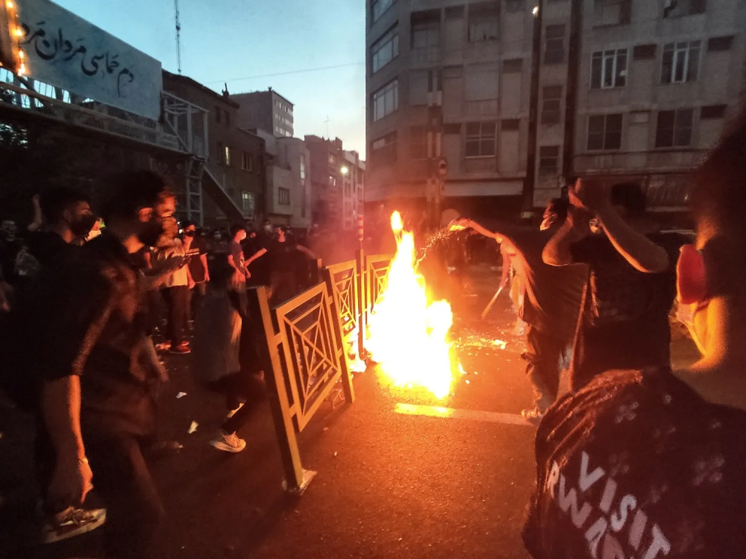 In this Wednesday, Sept. 21, 2022, photo taken by an individual not employed by the Associated Press and obtained by the AP outside Iran, protesters make fire and block the street during a protest over the death of a woman who was detained by the morality police, in downtown Tehran, Iran. (AP)