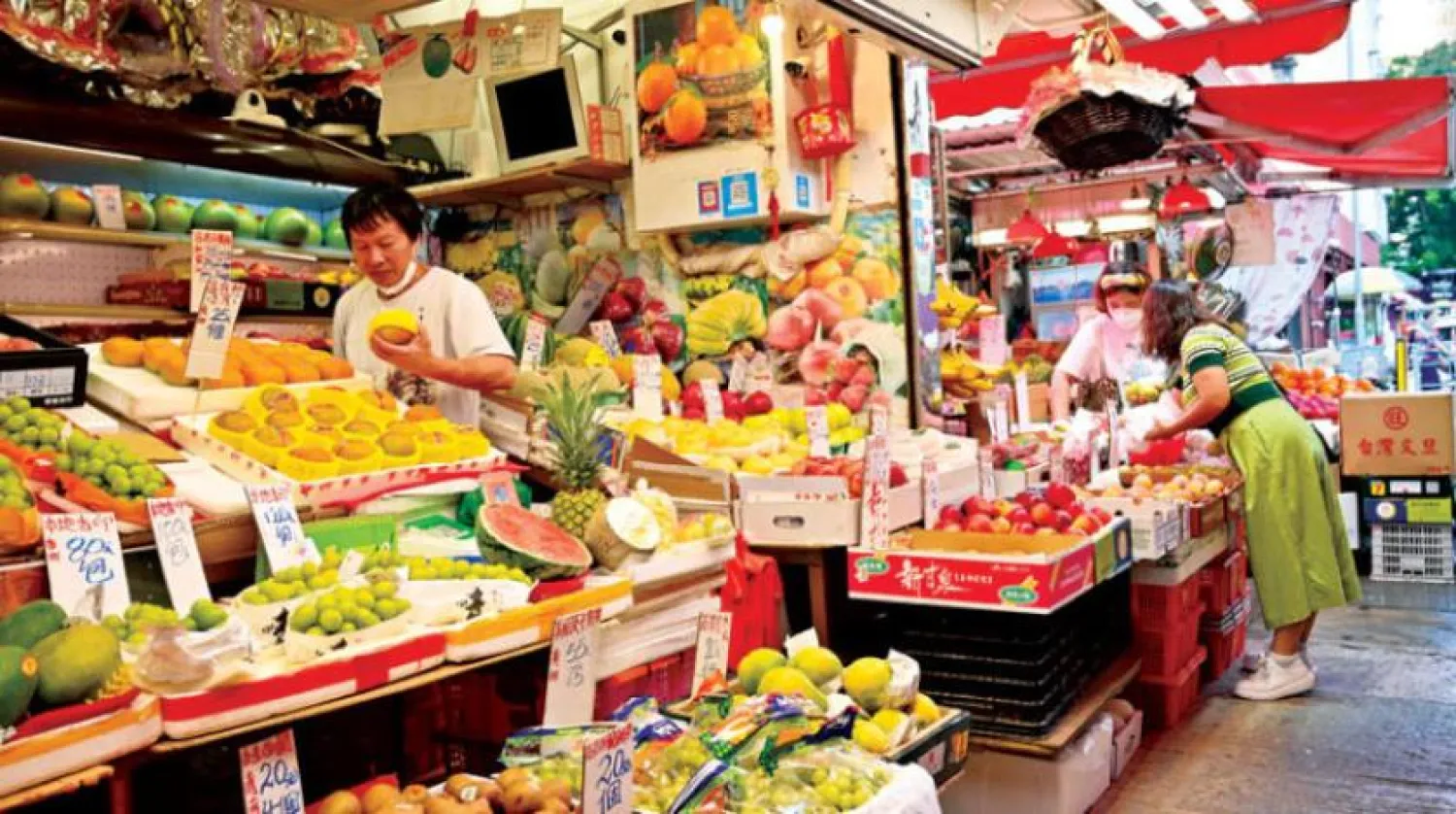 People shop for fruits and vegetables at a market in Hong Kong. (AFP)