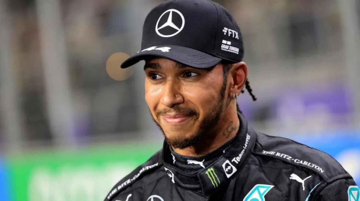 Mercedes driver Lewis Hamilton, of Britain, smiles, after winning the pole position during qualifying for the Formula One Saudi Arabian Grand Prix auto race on Dec. 4, 2021, in Jeddah, Saudi Arabia. (AP)
