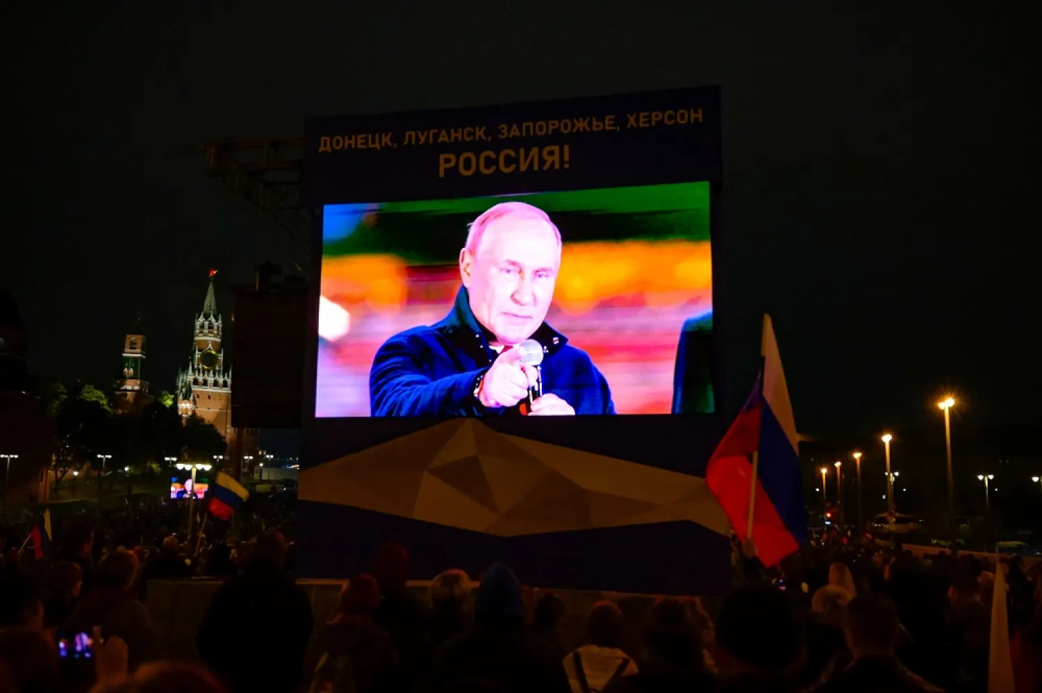 Russian President Vladimir Putin is seen on a screen as he addresses a rally and a concert marking the annexation of four regions of Ukraine, in central Moscow on September 30, 2022. (AFP)
