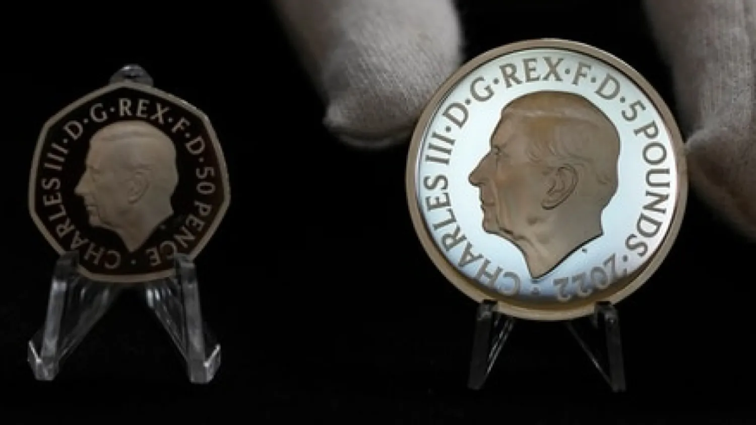 50 pence coin and 5 pounds coin with official coinage portrait of King Charles III AP
