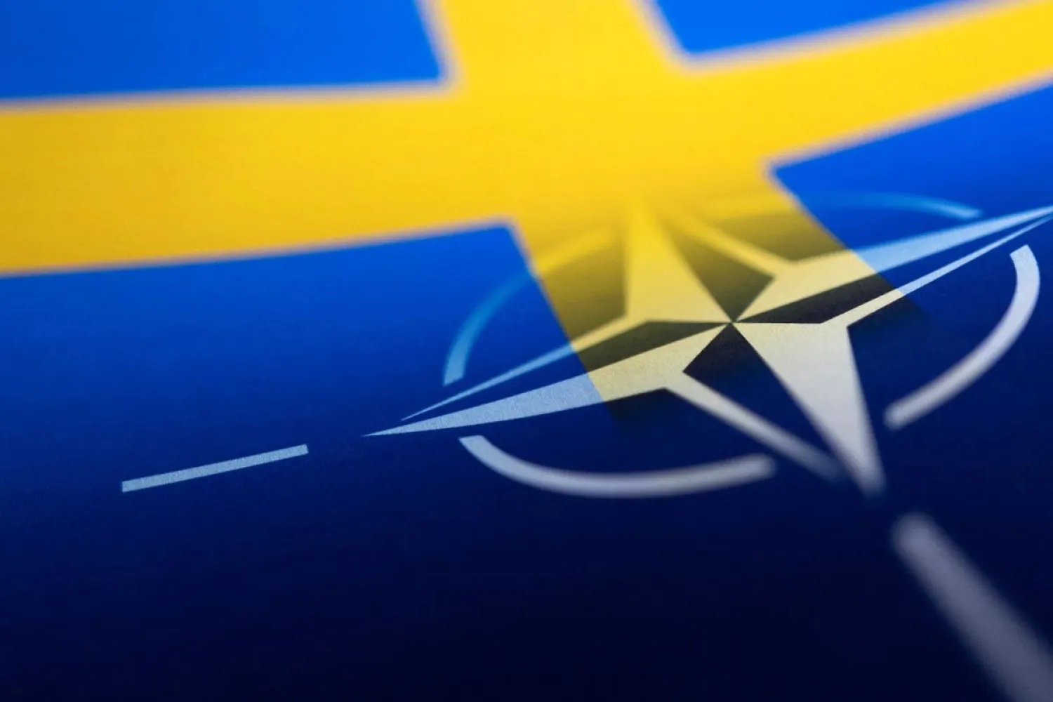 Swedish and NATO flags are seen printed on paper this illustration taken April 13, 2022. (Reuters)