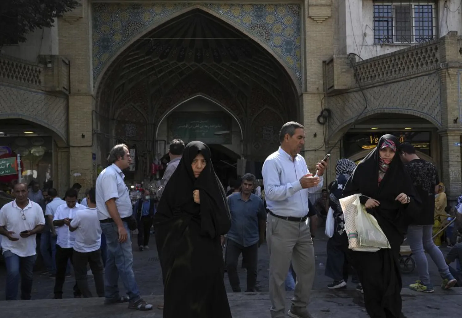 Two women walk around in the old main bazaar of Tehran with head-to-toe veiled Islamic wear, Iran, Saturday, Oct. 1, 2022. (AP Photo/Vahid Salemi)
