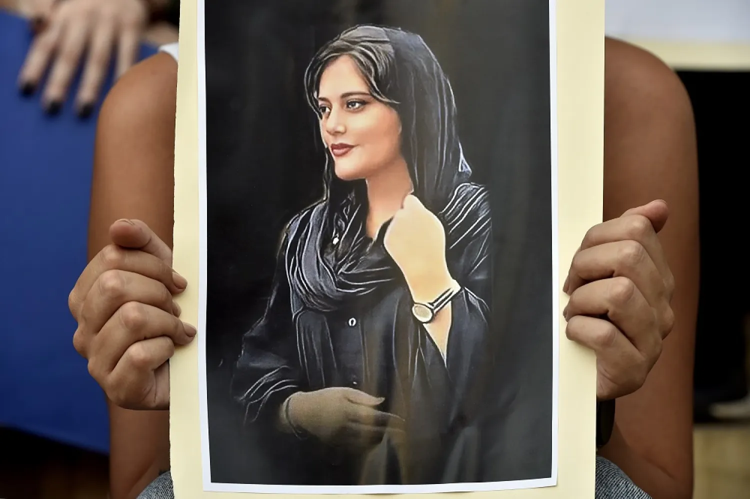A Lebanese activist holds a poster depicting deceased Mahsa Amini during a protest organized by feminist groups in support of women protesters in Iran, following Amini's death, outside the Lebanese National Museum in Beirut, Lebanon, 02 October 2022. (EPA)
