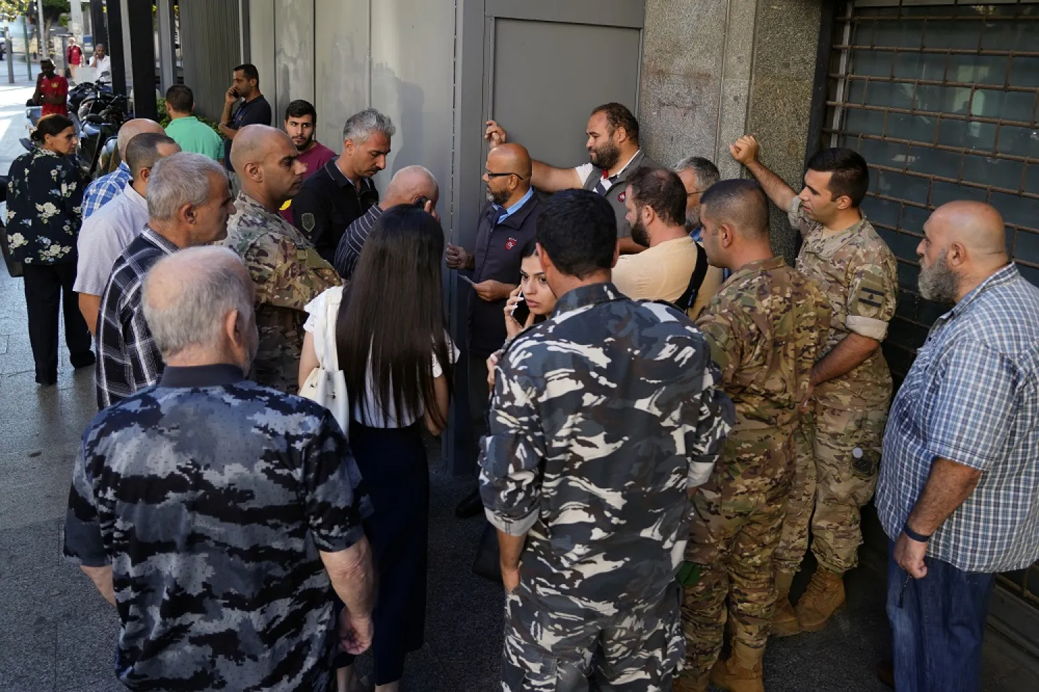 People waiting outside a Fransabank branch to withdraw money, in Beirut, Lebanon, Monday, Sept. 26, 2022. (AP)