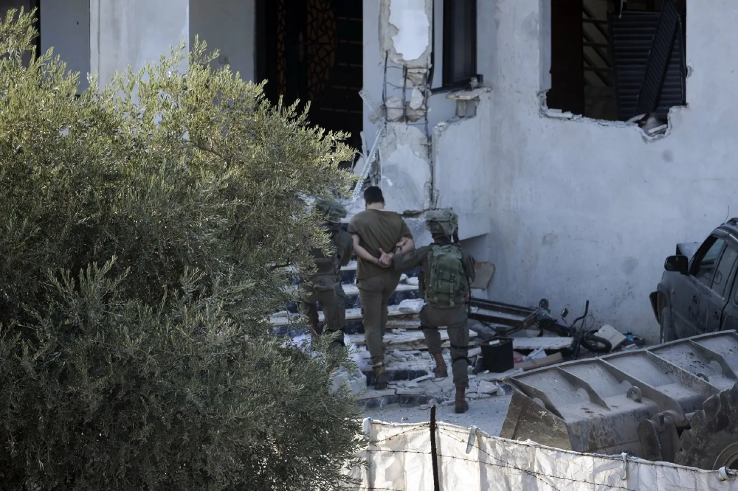 Israeli soldiers arrest a Palestinian man during a raid in the village of Deir al-Hatab near the West Bank city of Nablus, Wednesday, Oct. 5, 2022. (AP)