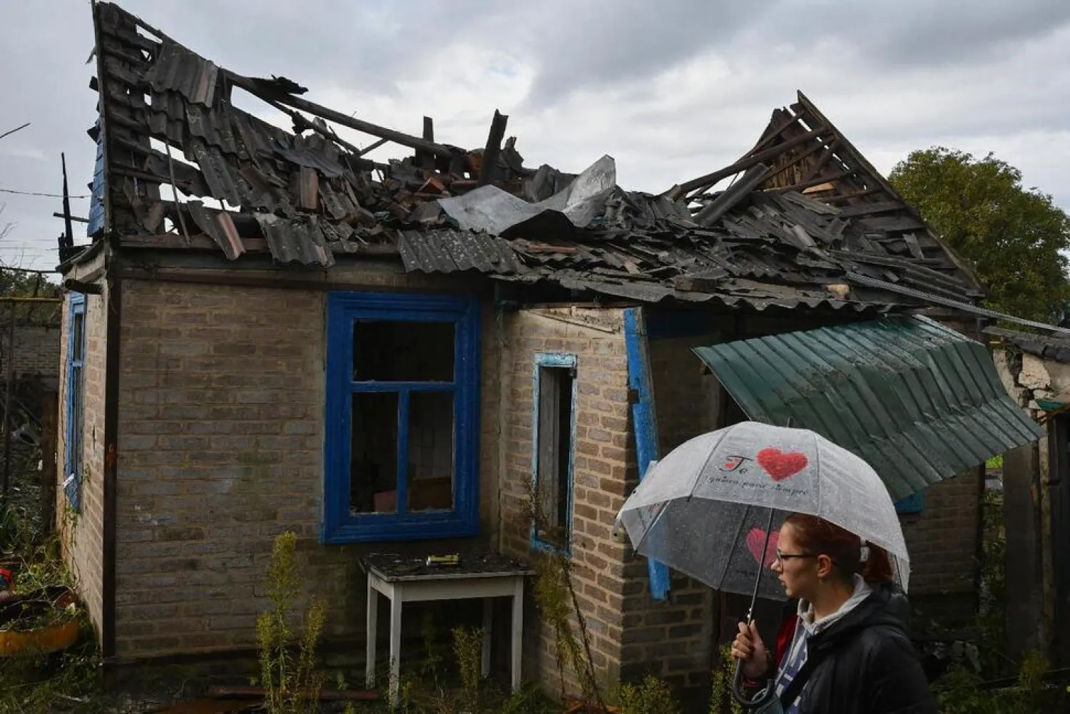 Local resident Ekaterina, 22, stands next to her residential building that was damaged after an overnight Russian attack in Kramatorsk, Ukraine, Tuesday, Oct. 4, 2022. (AP)