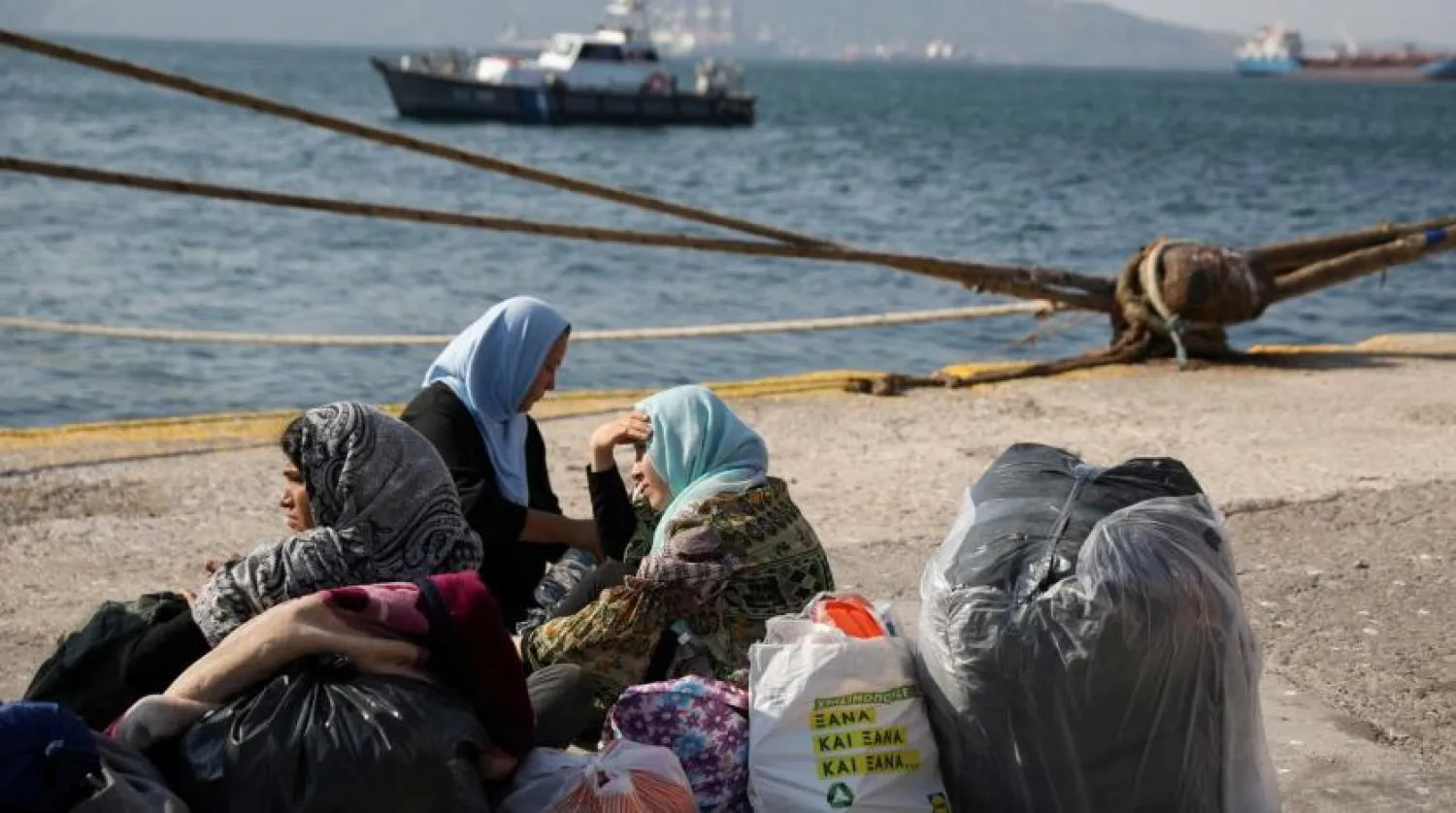 FILE PHOTO: Refugees and migrants wait to be transferred to camps on the mainland, at the port of Elefsina near Athens Greece, October 22, 2019. REUTERS/Costas Baltas/File Photo
