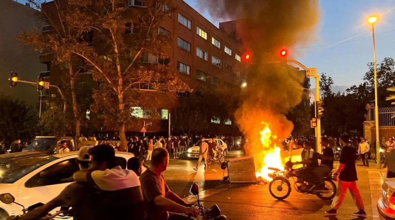 A police motorcycle burns during a protest over the death of Mahsa Amini, a woman who died after being arrested by the country's "morality police", in Tehran, Iran September 19, 2022. (West Asia News Agency via Reuters)
