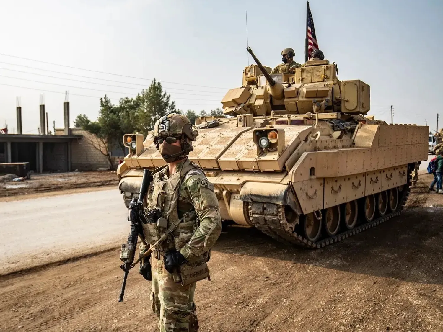 US troops patrol along the streets of the Syrian town of al-Jawadiyah, on December 17, 2020. (AFP)