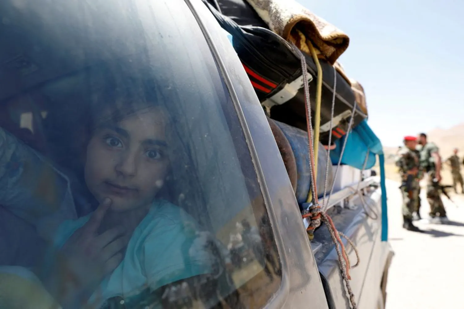 A Syrian refugee girl who left Lebanon looks through a window as she arrives in Qalamoun, Syria June 28, 2018. REUTERS/Omar Sanadiki/File Photo