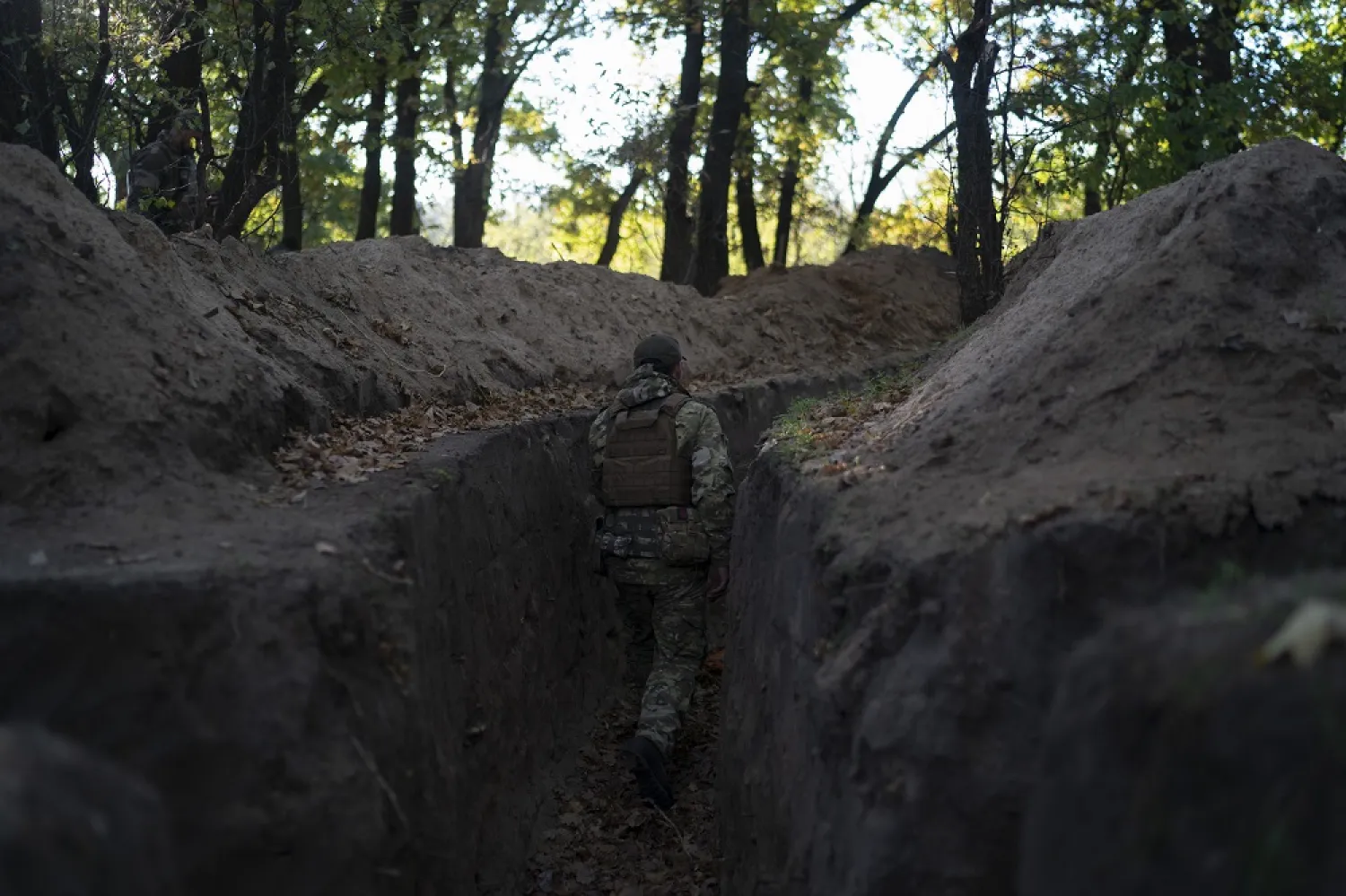 A Ukrainian serviceman checks the trenches dug by Russian soldiers in a retaken area in Kherson region, Ukraine, Wednesday, Oct. 12, 2022. (AP)