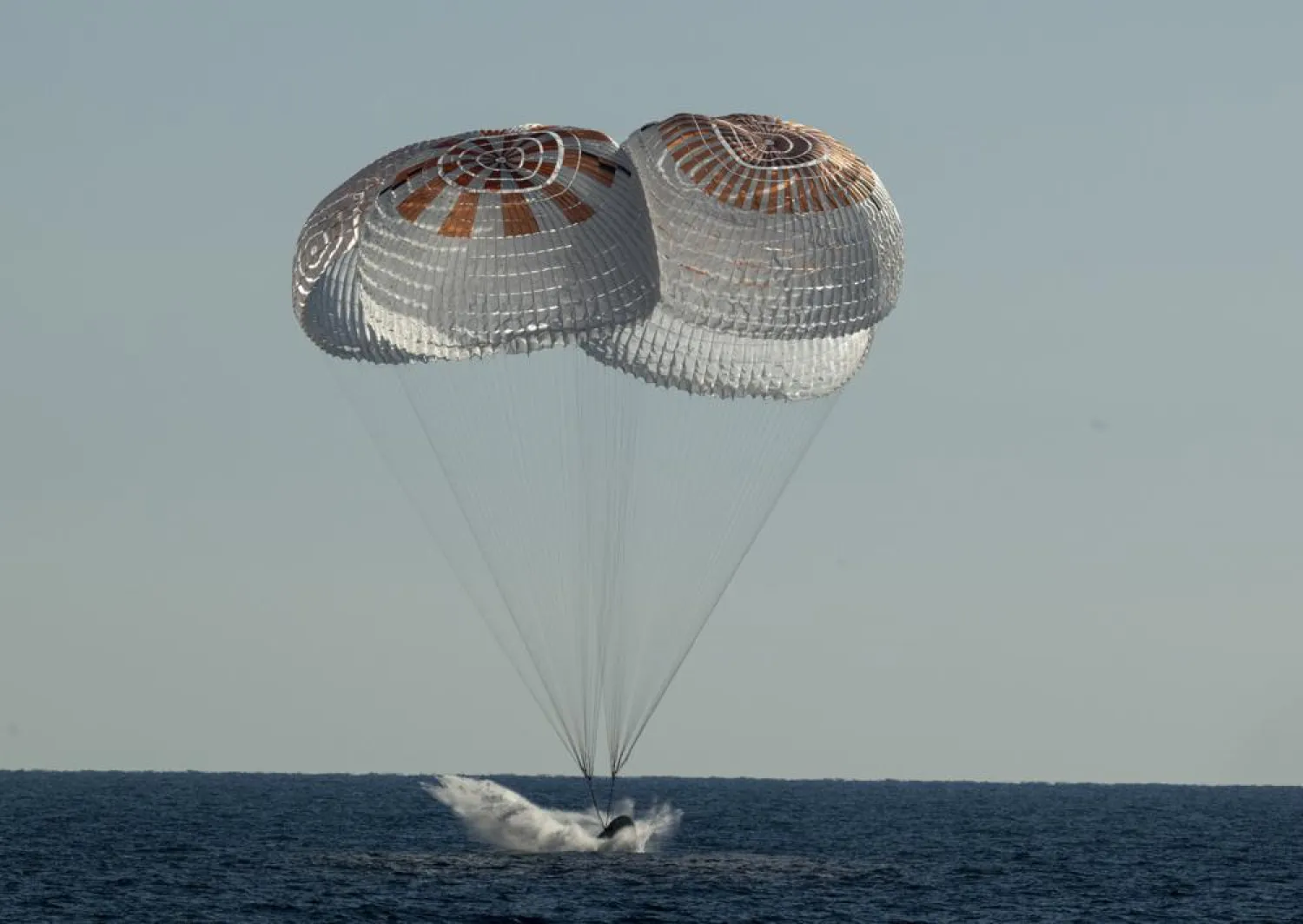 In this photo provided by NASA, the SpaceX Crew Dragon Freedom capsule splashes down in the Atlantic Ocean off Florida in a return trip from the International Space Station on Friday, Oct. 14, 2022. (Bill Ingalls/NASA via AP)
