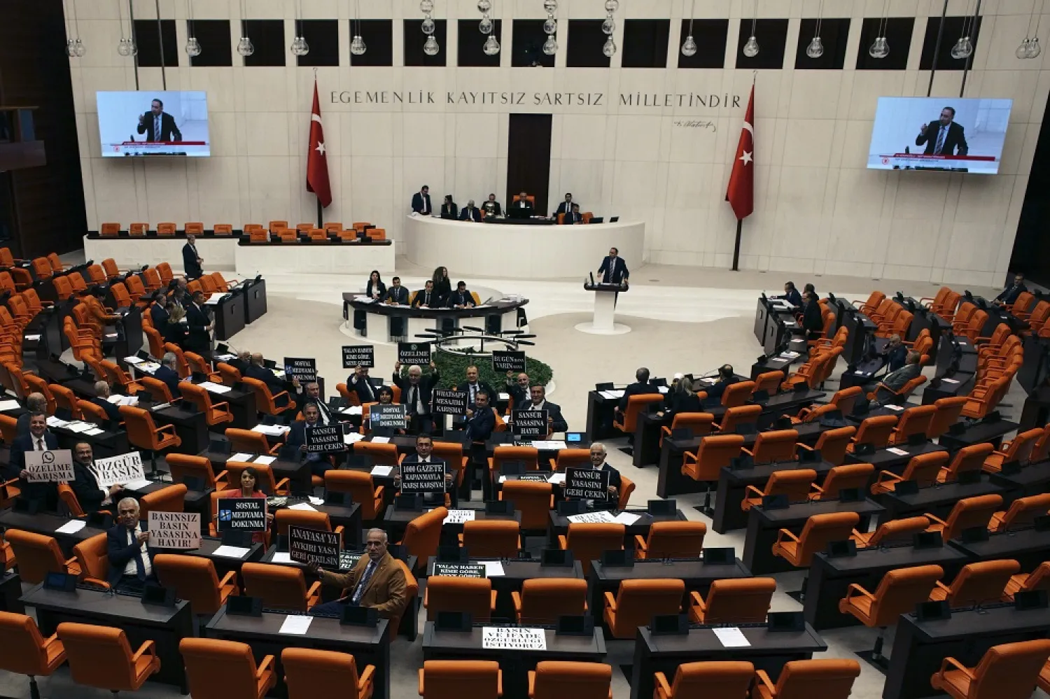 Lawmakers from Türkiye's main opposition Republican People's Party hold up placards protesting against the passing of a new bill at the parliament, in Ankara, Türkiye, Tuesday, Oct. 11, 2022. (AP)