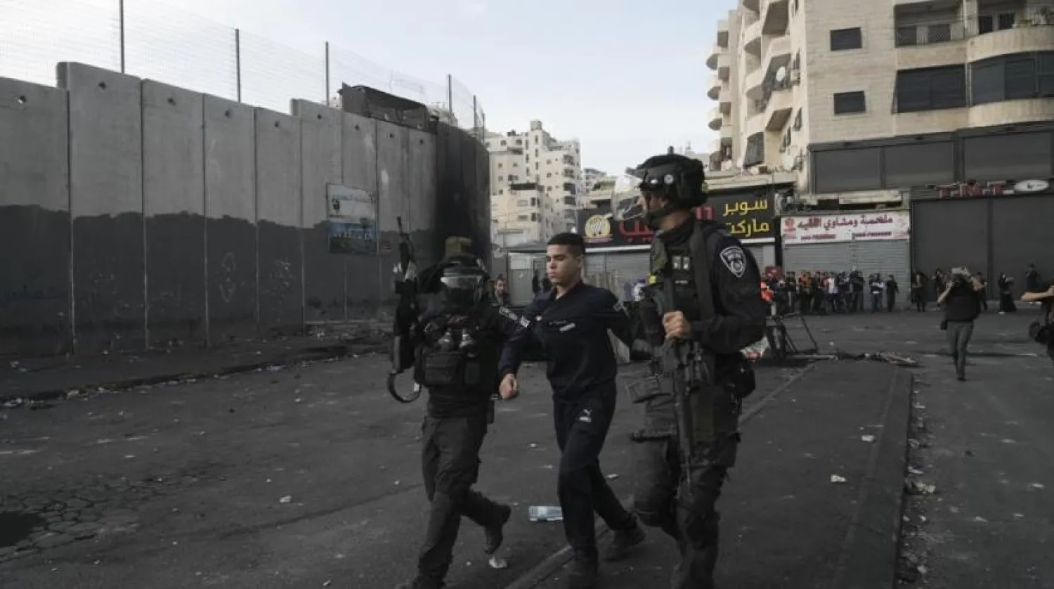 Israeli police arrests a Palestinian during clashes in Shuafat refugee camp in Jerusalem, Wednesday, Oct.12. 2022. (AP Photo/Mahmoud Illean)
