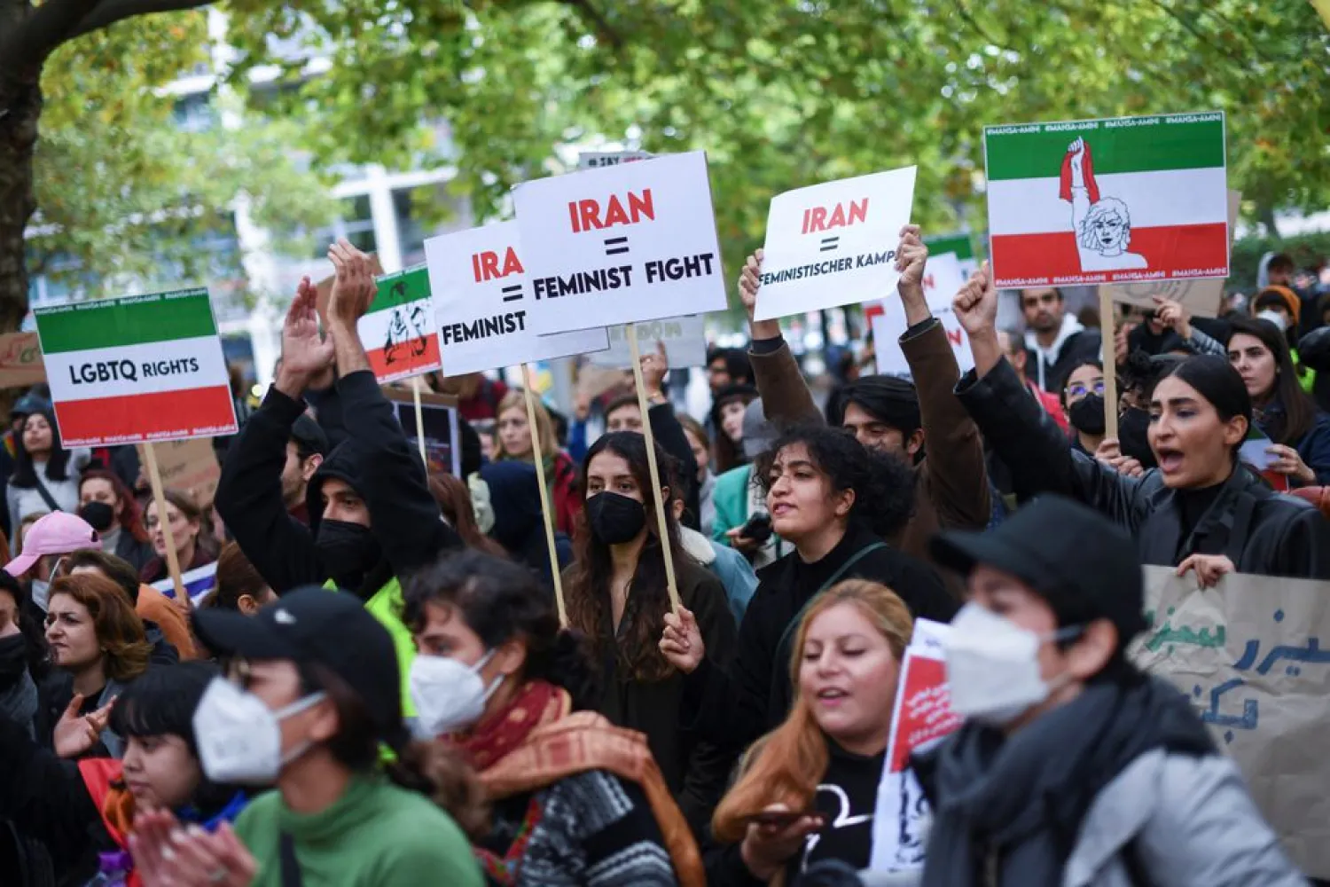 Protesters hold signs at a demonstration, following the death of Mahsa Amini, a woman who died last week in Tehran after being arrested by Iranian morality police, in Berlin, Germany September 24, 2022. REUTERS/Annegret Hilse


