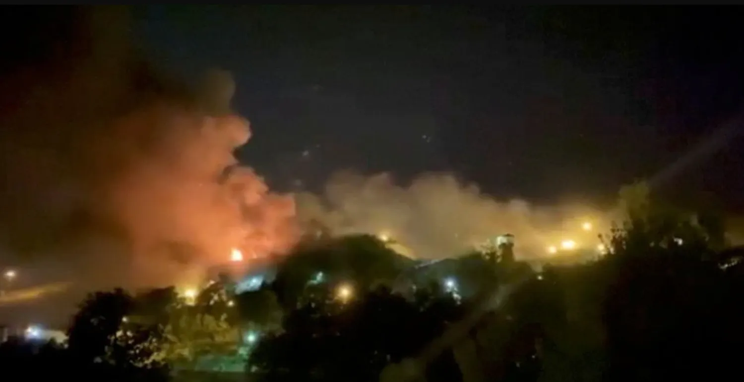 A view of smoke rising from Evin Prison in Tehran, Iran, October 15, 2022 in this still image take from a video obtained by Reuters.





