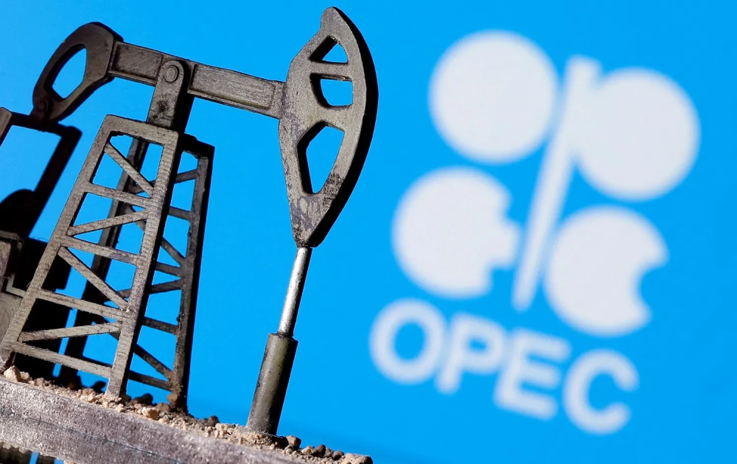 A 3D printed oil pump jack is seen in front of displayed OPEC logo in this illustration picture, April 14, 2020. (Reuters)