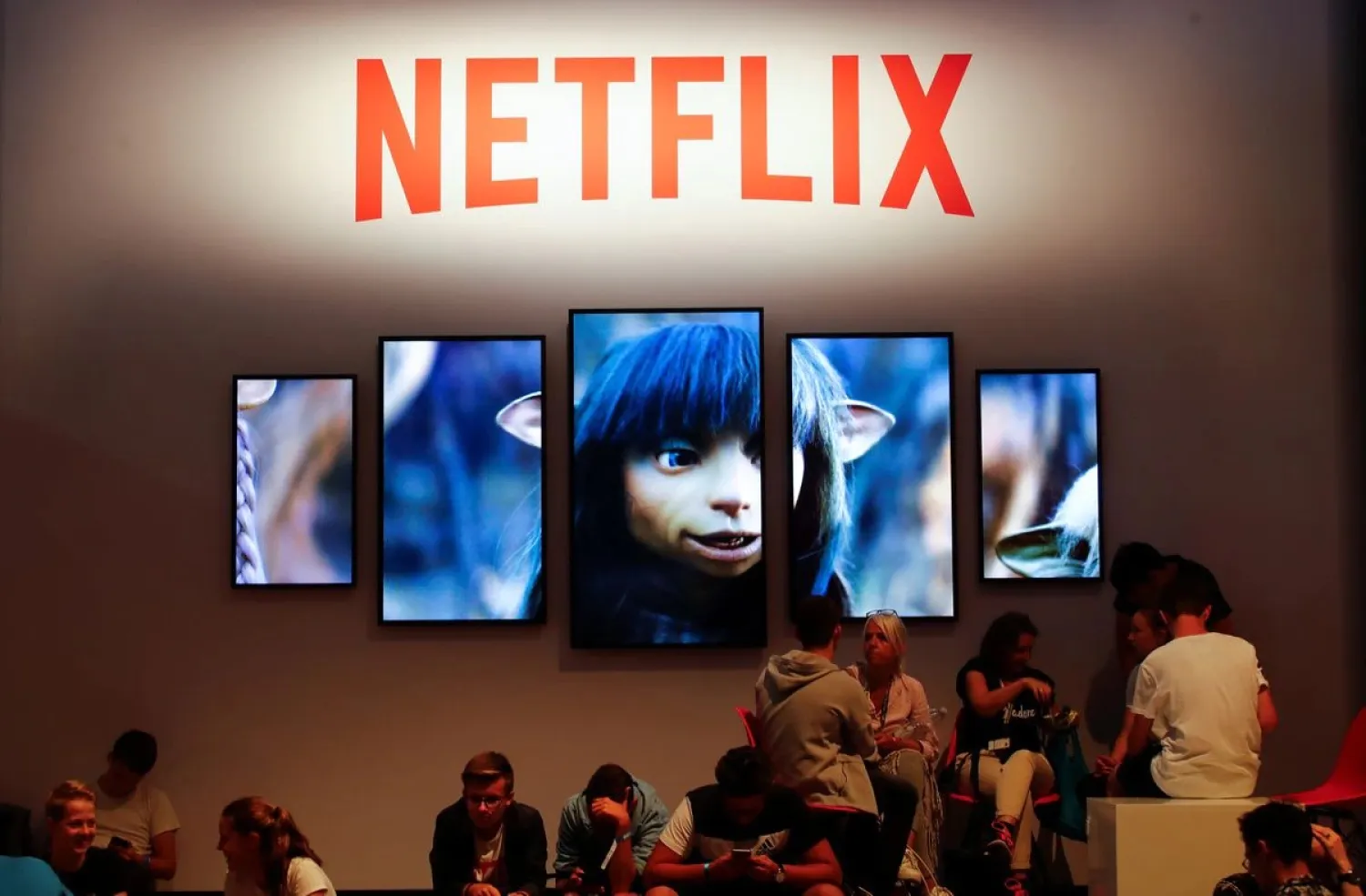 Gamers and visitors take a rest at the booth of Netflix during Europe's leading digital games fair Gamescom, which showcases the latest trends of the computer gaming scene in Cologne, Germany, August 21, 2019. REUTERS/Wolfgang Rattay - RC139FD73470