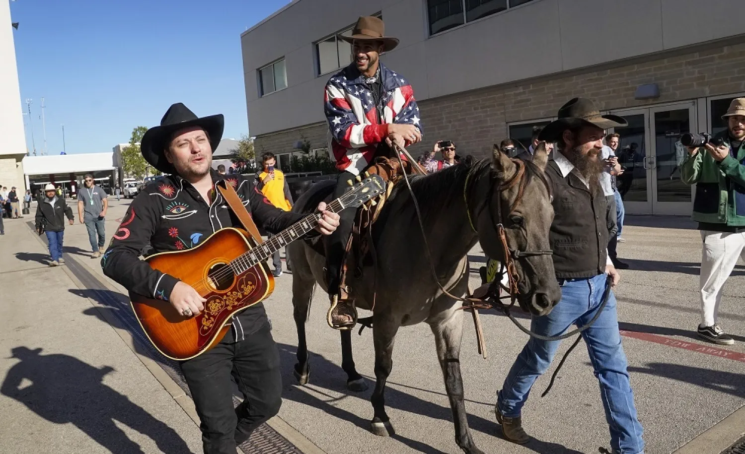 Australian McLaren F1 Team driver Daniel Ricciardo arrives in the paddock on horseback at the Circuit of The Americas in Austin, Texas, USA, 20 October 2022. (EPA)