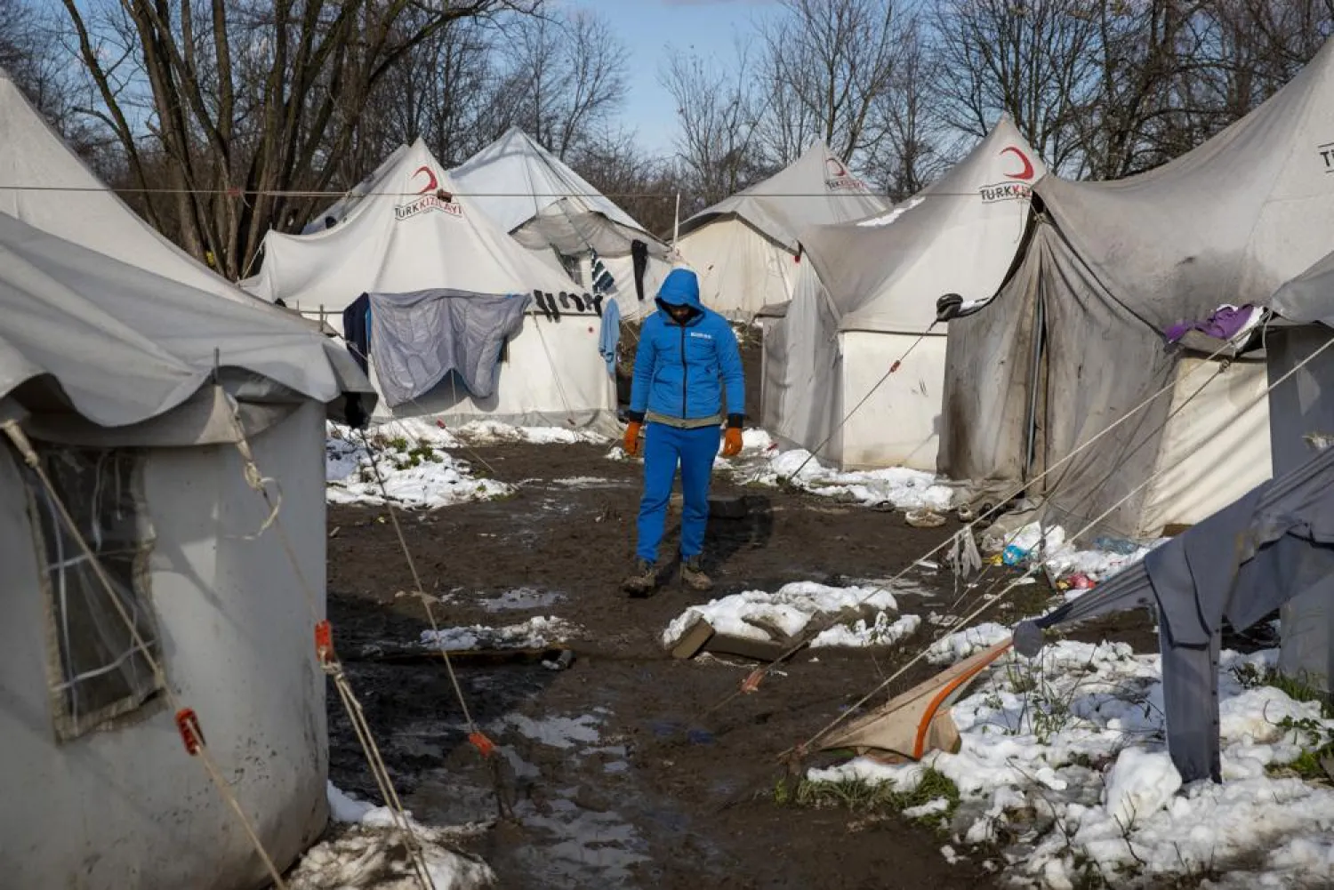 A migrant walks between tents at the Vucjak refugee camp outside Bihac, northwestern Bosnia, Friday, Dec. 6, 2019. (AP)