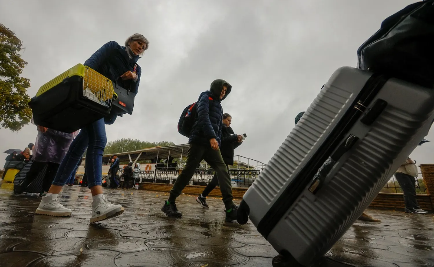 Civilians evacuated from the Russian-controlled city of Kherson walk from a ferry to board a bus heading to Crimea, in the town of Oleshky, Kherson region, Russian-controlled Ukraine October 23, 2022. (Reuters)