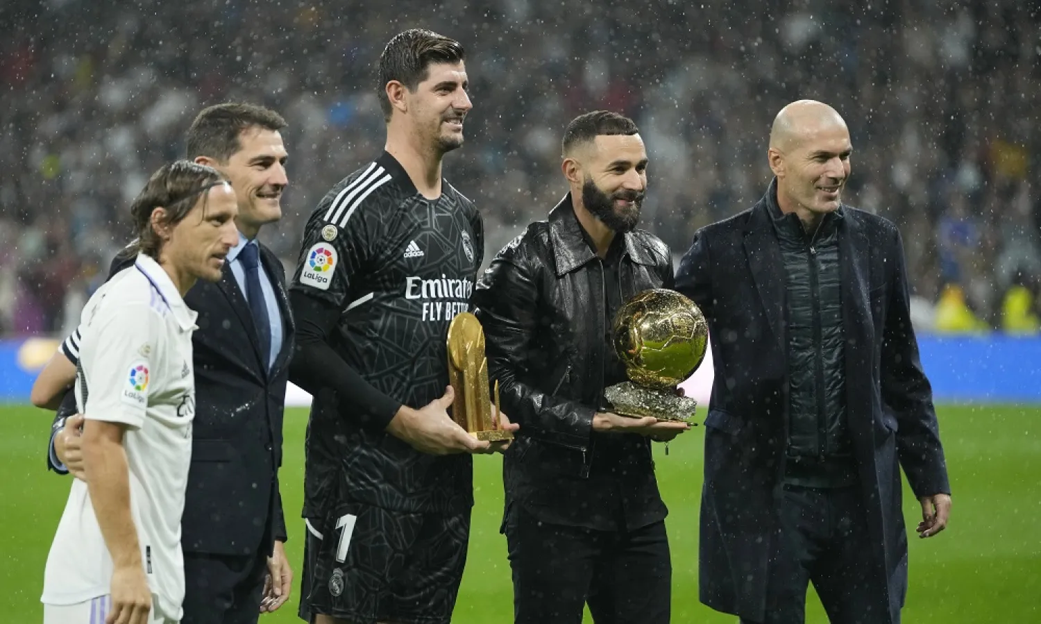 From left: Real Madrid's Luka Modric, former team's goalkeeper Iker Casillas, goalkeeper Thibaut Courtois, holding the Yashin Award, Karim Benzema, holding the 2022 Ballon d'Or, and Zinedine Zidane pose for a picture prior the Spanish La Liga match between Real Madrid and Sevilla at the Santiago Bernabeu stadium in Madrid, Saturday, Oct. 22, 2022. (AP)