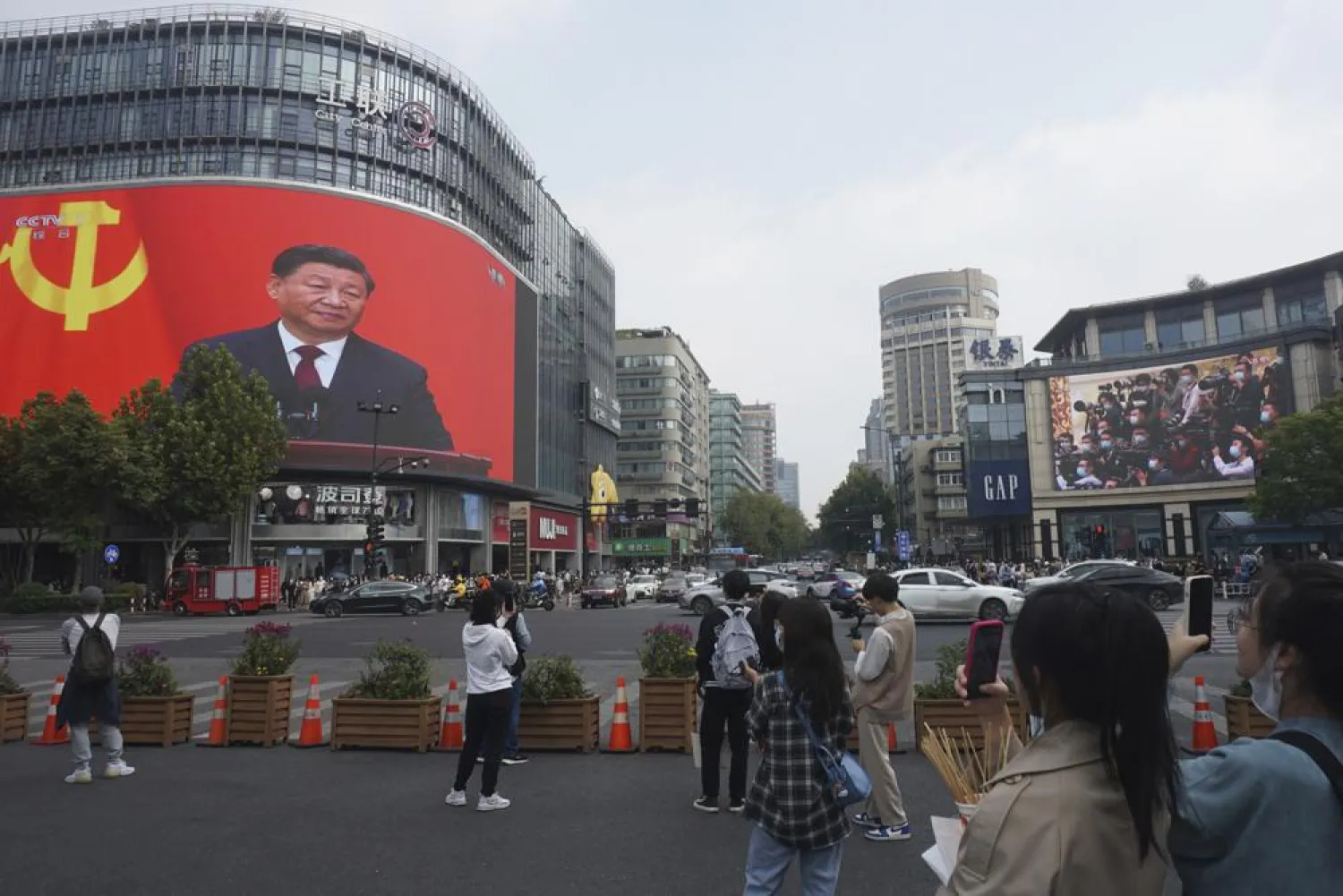 Chinese President Xi Jinping is seen at the end of the Chinese Communist Party's 20th Party Congress on a giant screen a commercial district of Hangzhou in eastern China's Zhejiang province on Sunday, Oct 23, 2022. (AP)