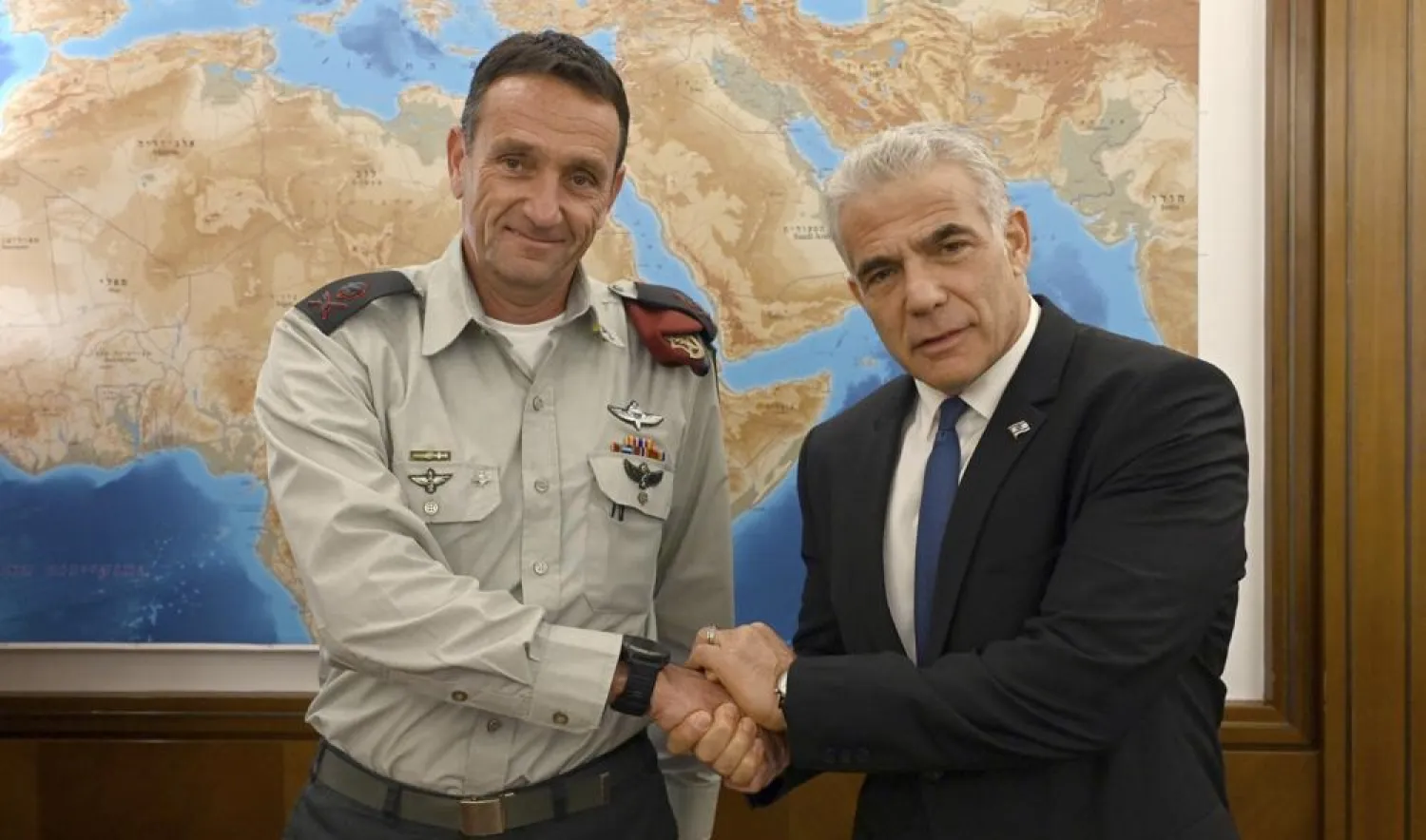 In this photo provided by the Government Press Office, Israeli Prime Minister Yair Lapid, right, poses for a photo with Israel's next military chief Maj. Gen. Herzi Halevi in Jerusalem, Aug. 3, 2022. (Israeli Government Press Office via AP)