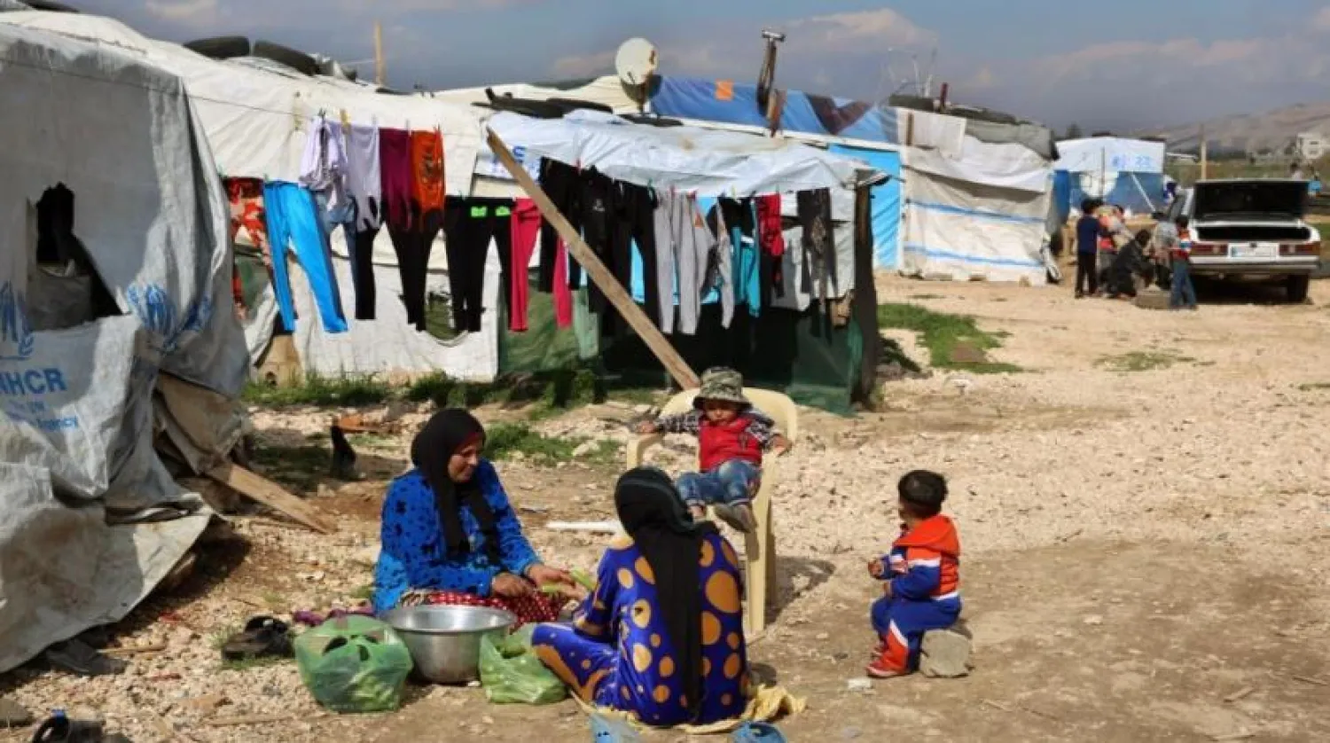 Syrian women prepare food for their family outside their tents, at a Syrian refugee camp in the town of Bar Elias, in Lebanon's Bekaa Valley, March 29, 2016. (AP)
