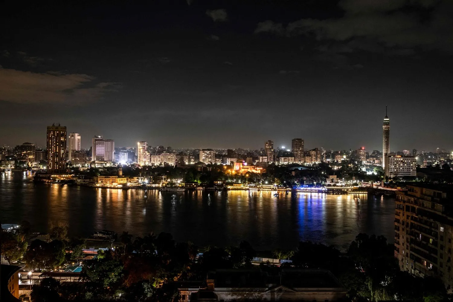 This picture taken on October 25, 2022 shows a view of the southern part of the Nile island of Zamalek in the center of Egypt's capital Cairo, with its landmark Cairo Opera House (C) and Cairo Tower (R). (AFP)