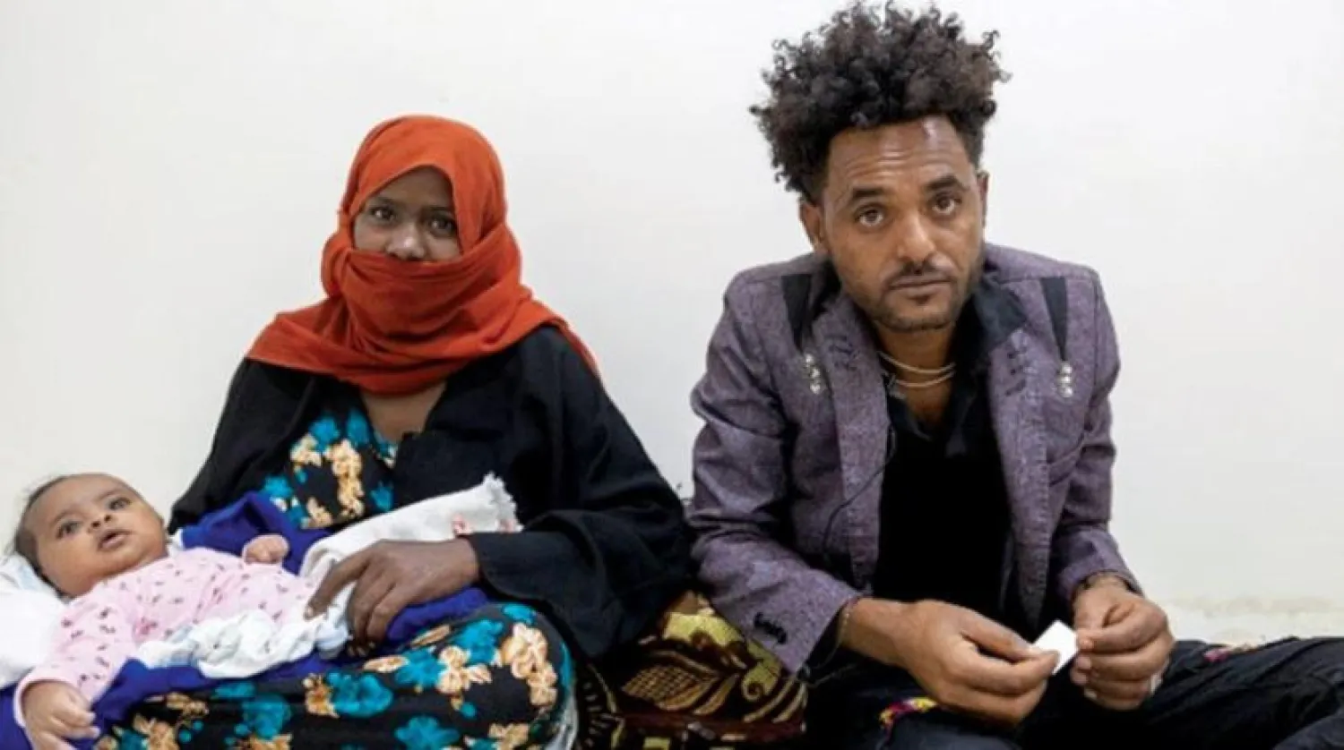 An Ethiopian migrant with his family who was flown back to his country by the International Organization for Migration from Yemen (United Nations)
