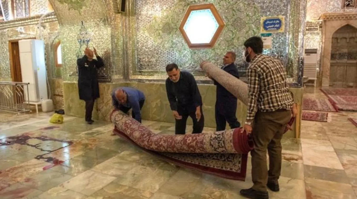 Shah Cheragh Shrine personnel members clean after an attack in Shiraz, Iran October 26, 2022. Amin Berenjkar/WANA (West Asia News Agency) via Reuters