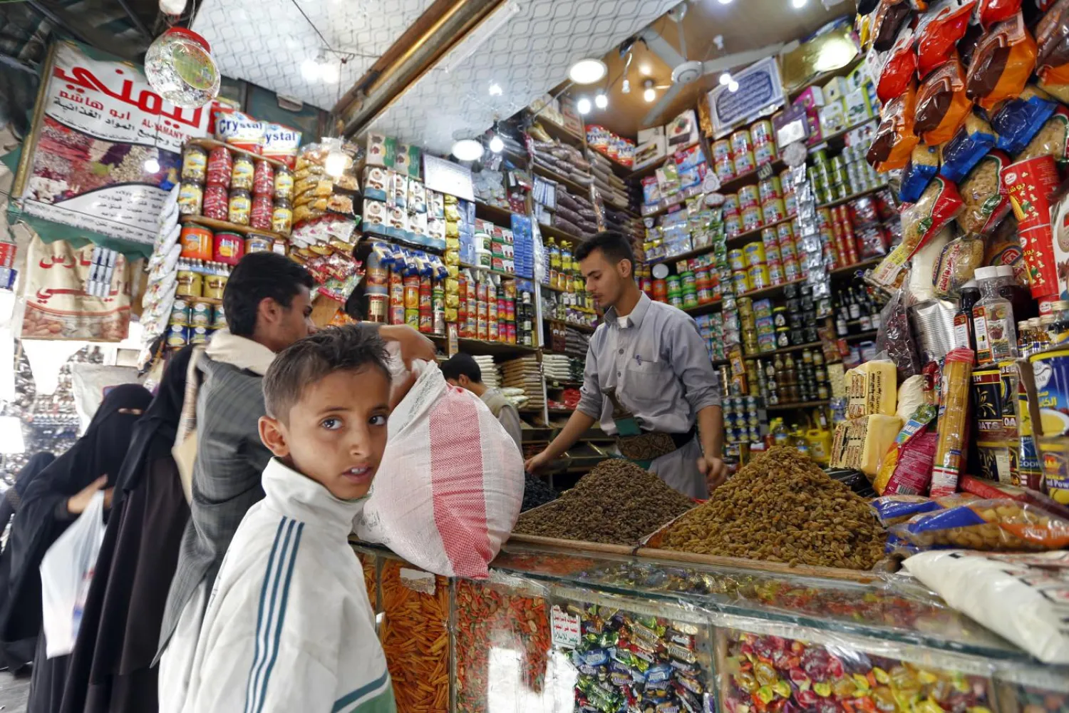 Yemenis shop in a market in the old city of the capital Sanaa (AFP)
