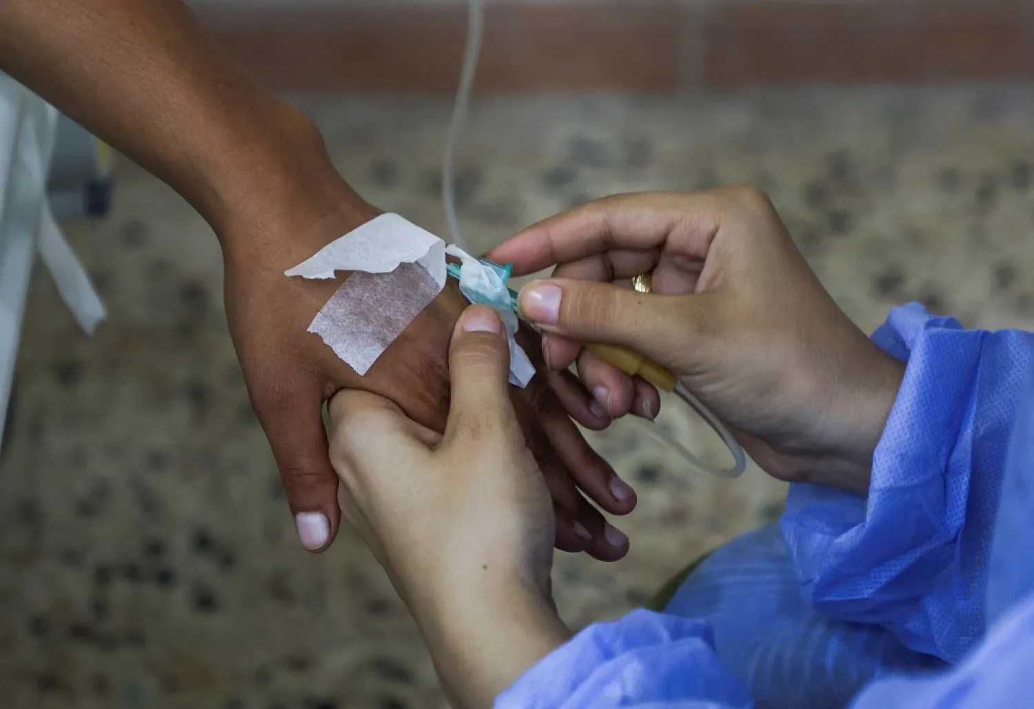 A suspected cholera patient receives treatment inside a field hospital in Bebnine, Akkar district, northern Lebanon October 28, 2022. (Reuters)