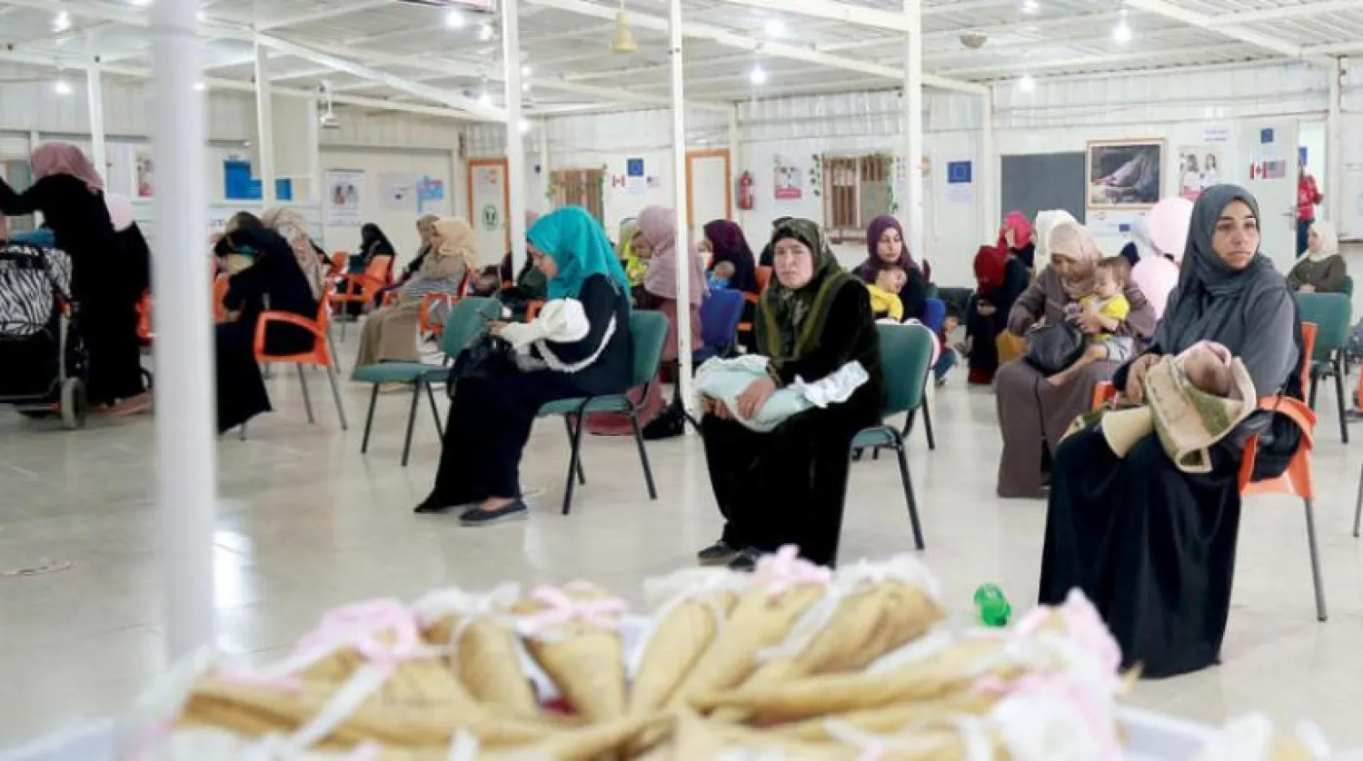 Syrian women wait at a clinic in the Zaatari camp - AFP