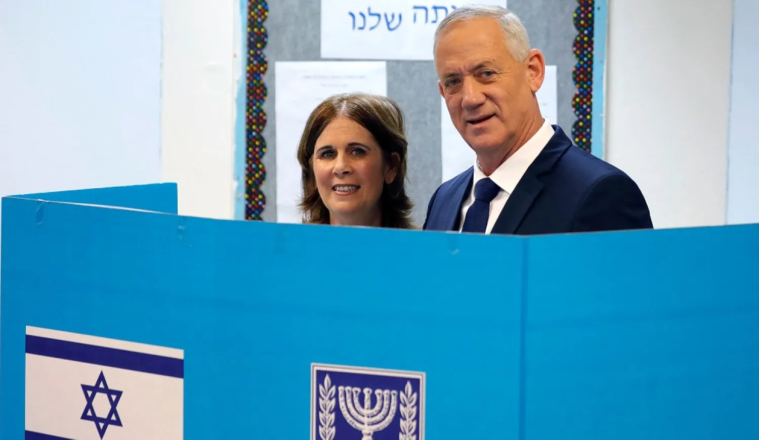 Israeli Defense Minister Benny Gantz (R), head of the new center-right "National Unity Party" or Hamahane Hamamlachti in Hebrew, and his wife Revital Gantz (L), vote at a polling station in the city of Rosh Haayin in central Israel on November 1, 2022.(AFP)