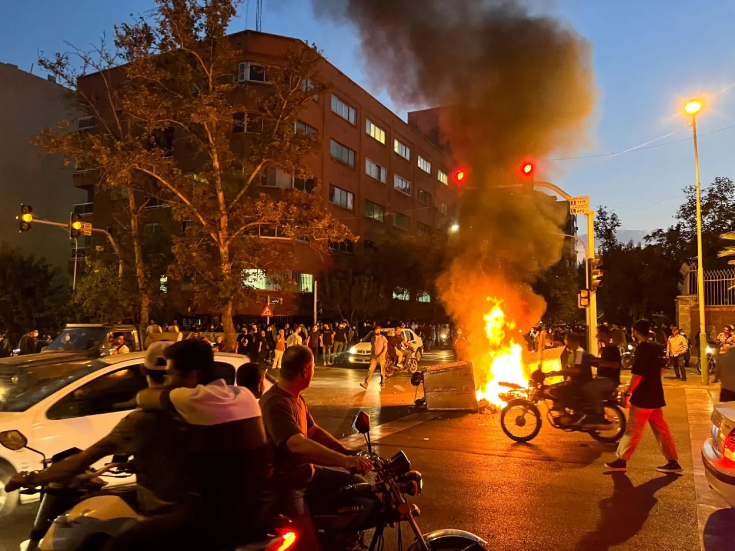 A police motorcycle burns during a protest over the death of Mahsa Amini, in Tehran, Iran September 19, 2022. WANA (West Asia News Agency) via REUTERS

 