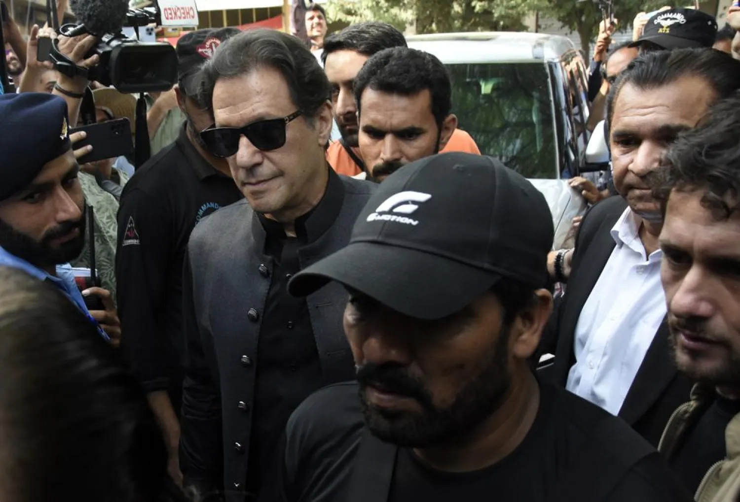 Former Pakistani Prime Minister Imran Khan, center left, arrives to the Islamabad High Court surrounded by security in Islamabad, Pakistan, Thursday, Sept. 22, 2022. (AP Photo/W.K. Yousafzai)
