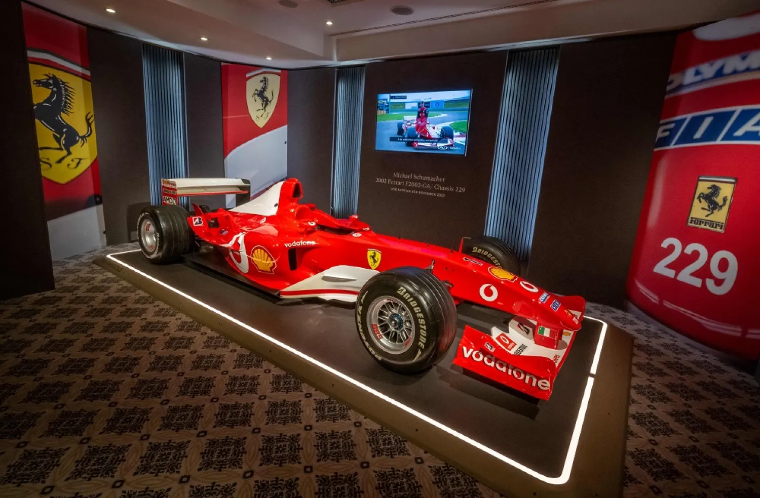 This photograph taken on November 4, 2022 shows F1 World Champion Michael Schumacher's Formula One Ferrari F2003 GA with "Chassis 229" during Sotheby's auction house preview in Geneva. (AFP)