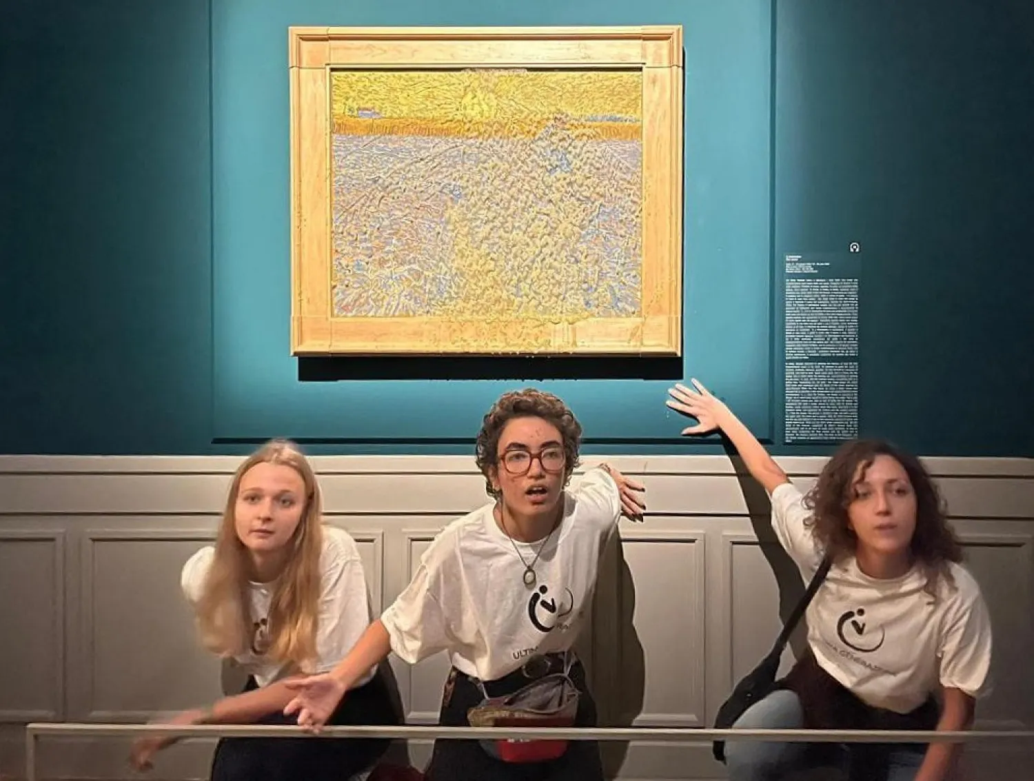 This photo obtained from Italian news agency Ansa shows Climate activists from Last Generation posing by "The Sower", an 1888 painting by Dutch artist Vincent van Gogh, after they threw pea soup at it on November 4, as it was on show at Rome's Palazzo Bonaparte. (ANSA / AFP)