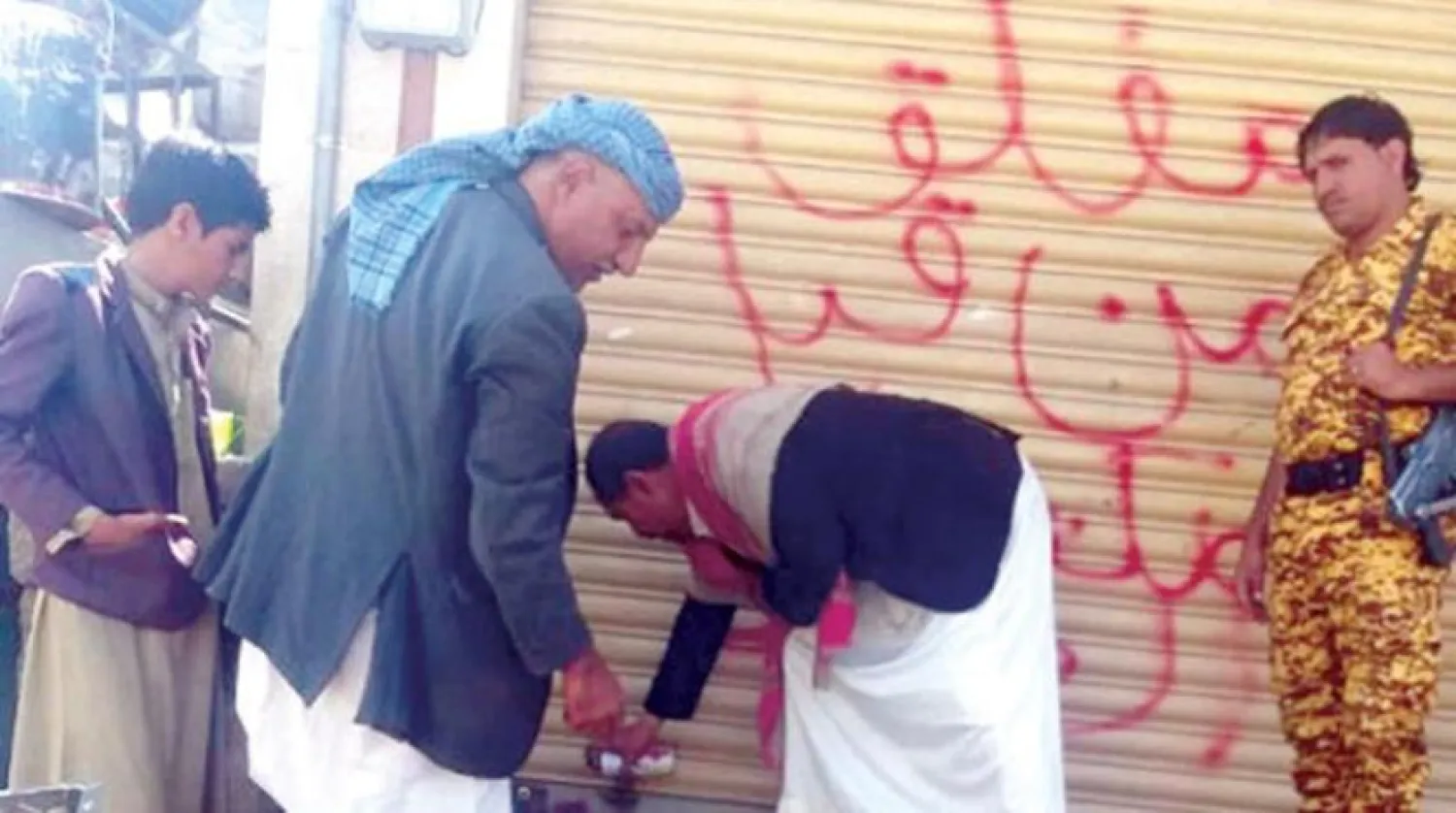 Houthis closing a store in Sanaa, Yemen (Houthi media)