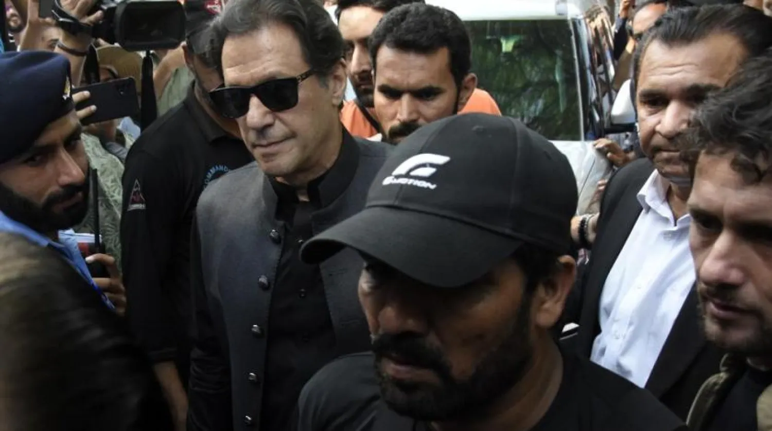 Former Pakistani Prime Minister Imran Khan, center left, arrives to the Islamabad High Court surrounded by security in Islamabad, Pakistan, Thursday, Sept. 22, 2022. (AP Photo/W.K. Yousafzai)
