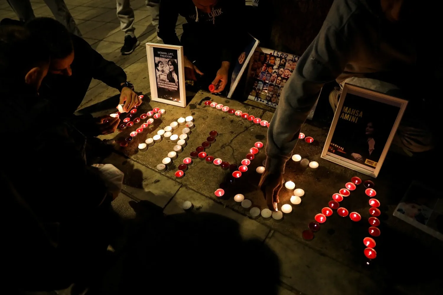 Demonstrators light candles during a protest following the death of Mahsa Amini in Athens, Greece, October 29, 2022. (Reuters)