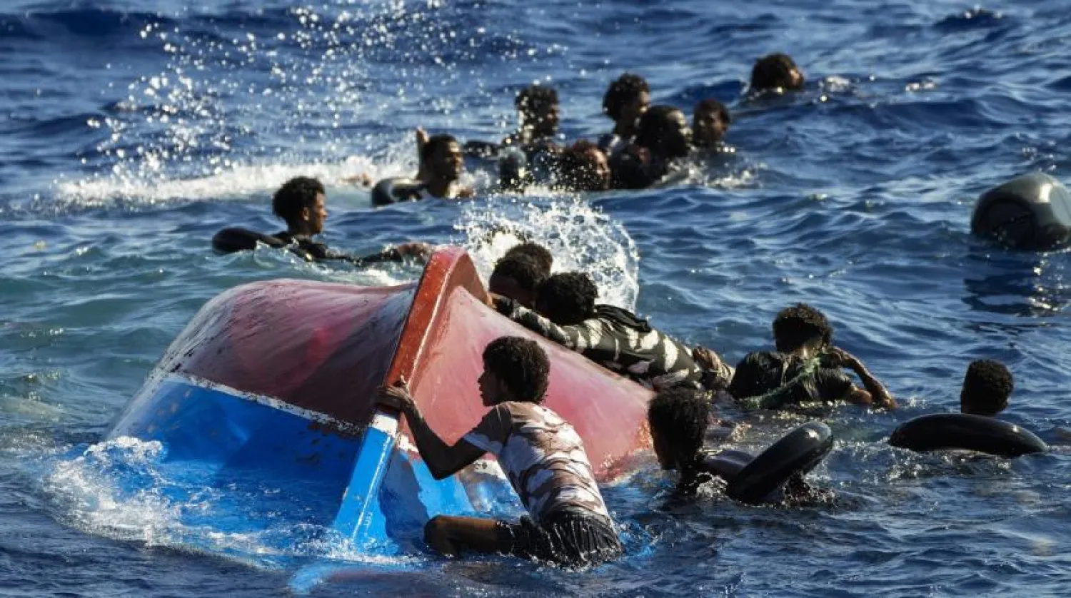 FILE - Migrants swim next to their overturned wooden boat during a rescue operation by Spanish NGO Open Arms at south of the Italian Lampedusa island at the Mediterranean sea, Aug. 11, 2022. (AP Photo/Francisco Seco, file)
