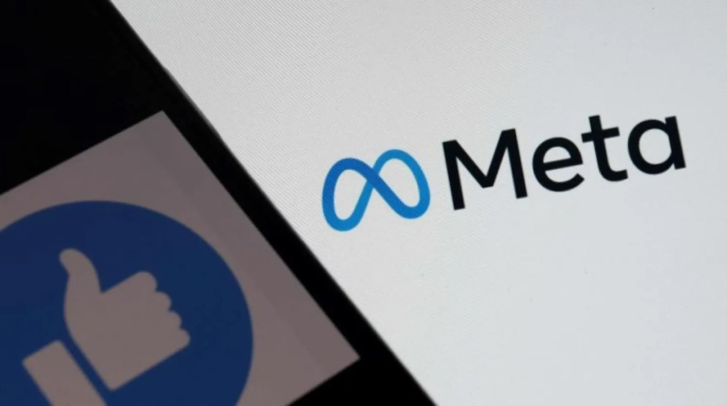 This file photo illustration taken on October 28, 2021, in Los Angeles, shows the Facebook-like logo on a smartphone in front of a computer screen showing the parent company META logo. (AFP)
