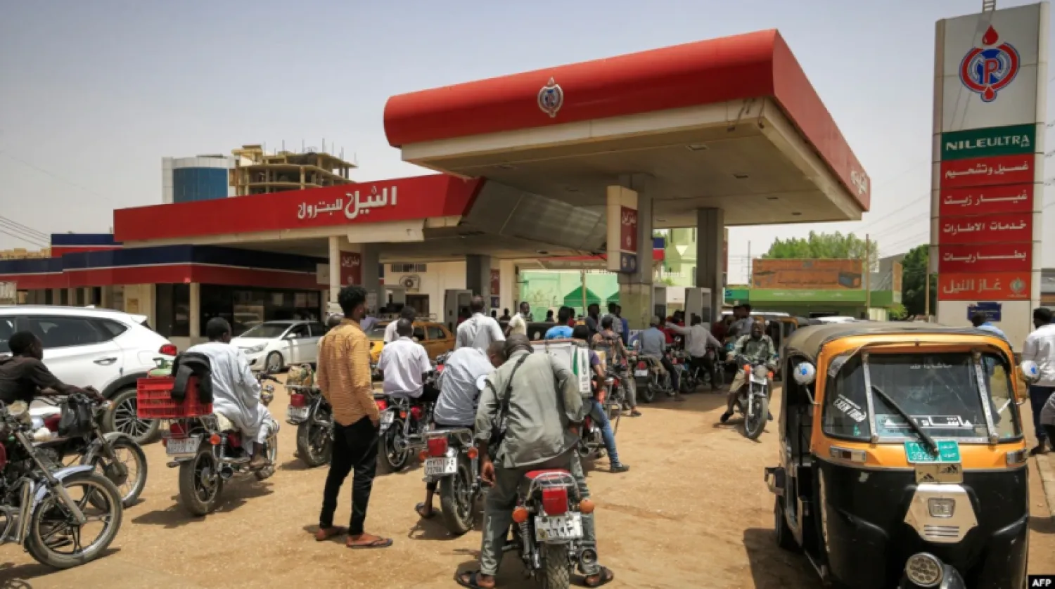 Motorcyclists queue-up for fuel at a gas station in al-Amarat district of Sudan's capital Khartoum on June 10, 2021.
