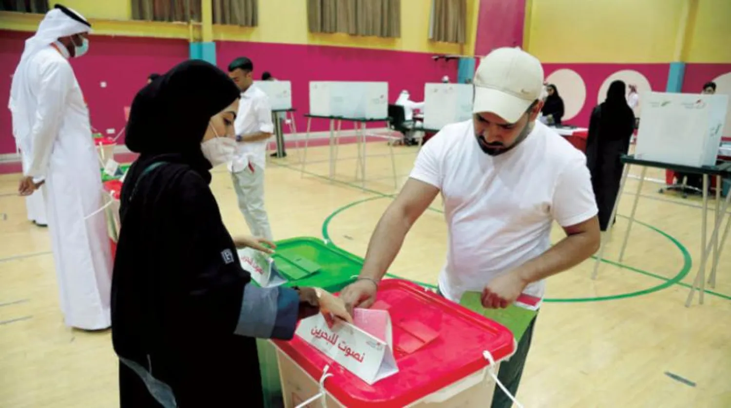 A Bahraini woman casts her vote at a polling station on Saturday (AFP)